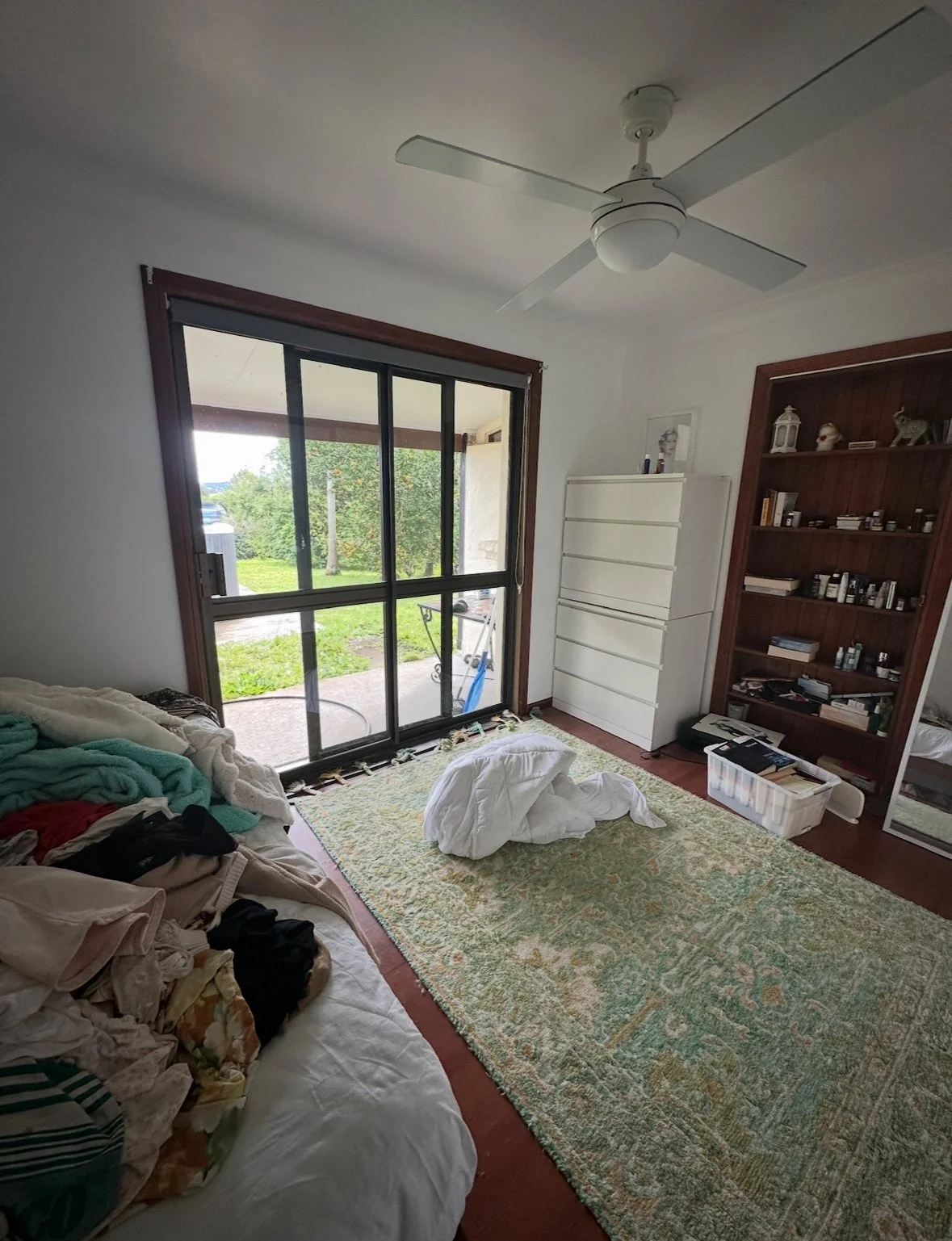 Spare room before — cluttered, used as storage, not functional or inviting